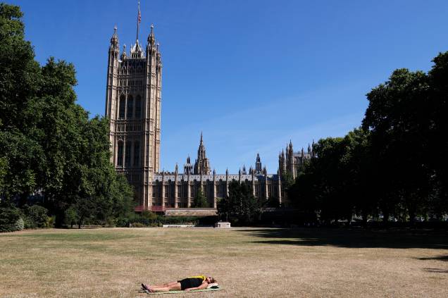 Uma mulher toma sol próximo das Casas do Parlamento em Londres, em 11/07/2022.