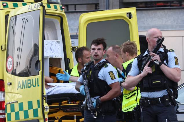 Uma ambulância e policiais armados na evacuação de pessoas no shopping Fields em Copenhague, Dinamarca, após um homem efetuar vários disparos contra pessoas, deixando mortos e feridos, em 03/07/2022. Uma ambulância e policiais armados na evacuação de pessoas no shopping Fields em Copenhague, Dinamarca, após um homem efetuar vários disparos contra pessoas, deixando mortos e feridos, em 03/07/2022.