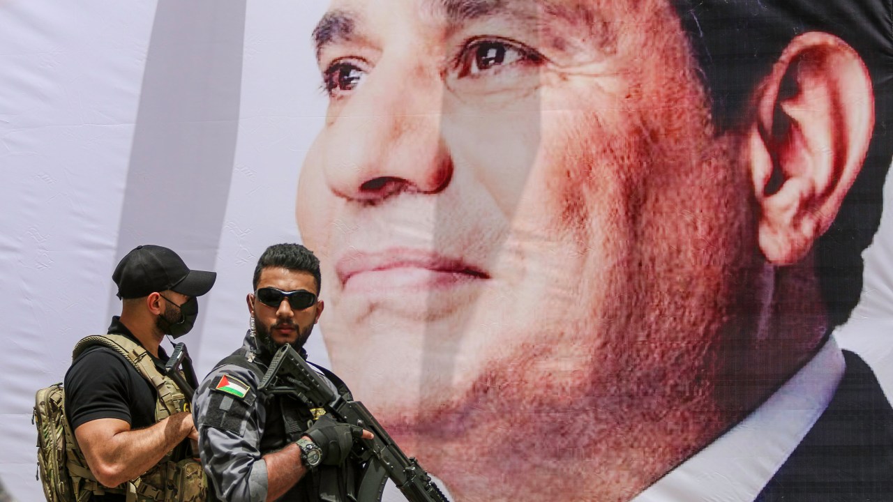 GAZA, PALESTINE - 2021/05/31: A member of Egyptian security stands guard by a banner showing Egyptian President Abdel Fattah al-Sisi during a meeting between the Egyptian intelligence chief and Hamas officials in Gaza City. Major General Abbas Kamel (Director of the Egyptian General Intelligence Directorate) met with Palestinian Hamas Gaza Chief Yahya Al-Sinwar in Gaza on 31st of May 2021 during an official visit to Israel and Palestinian territories to follow up on the Egypt-brokered ceasefire agreement between Palestinian armed groups and Israel. (Photo by Ahmed Zakot/SOPA Images/LightRocket via Getty Images)