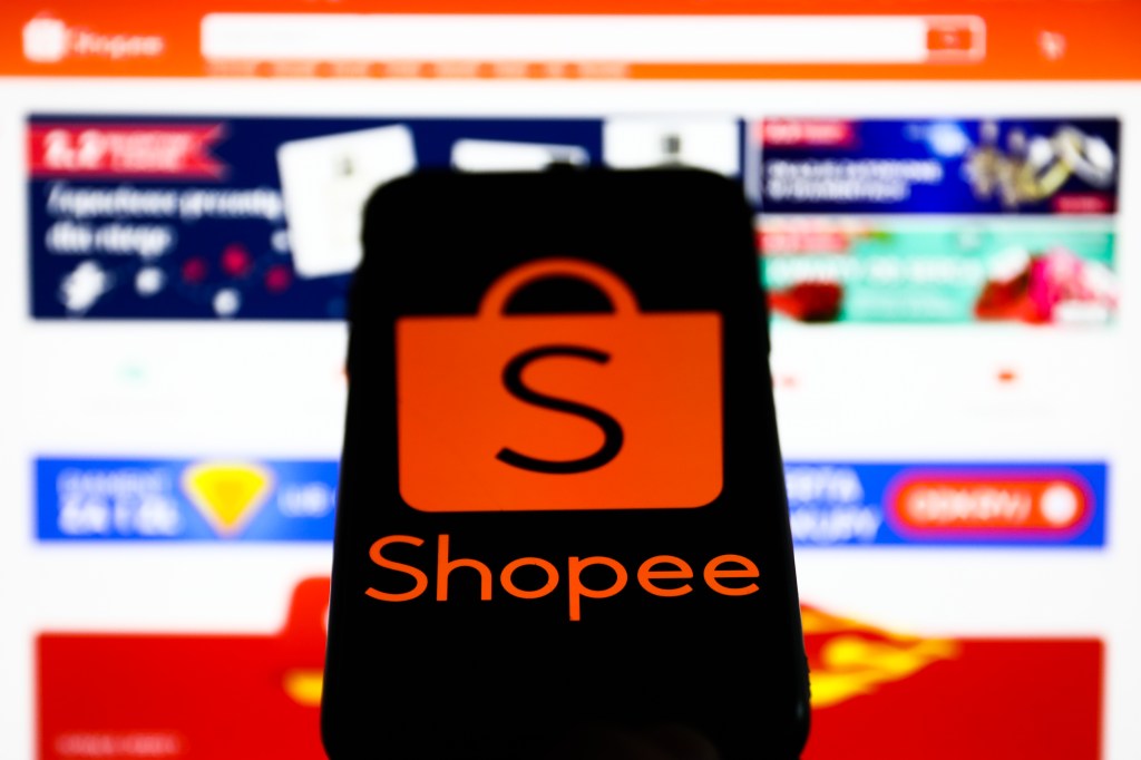 Shopee logo displayed on a phone screen and Shopee website displayed on a laptop screen are seen in this illustration photo taken in Krakow, Poland on January 25, 2022. (Photo by Jakub Porzycki/NurPhoto via Getty Images)
