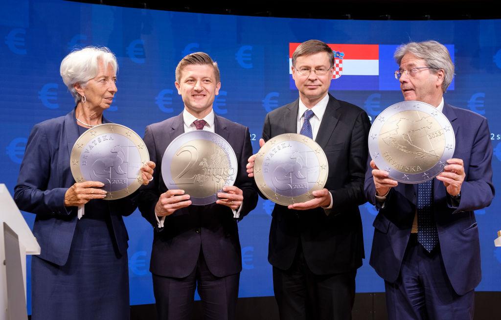 BRUSSELS, BELGIUM - JULY 12: (L to R) President of the European Central Bank (ECB) Christine Lagarde, the Croatian Minister of Finance Zdravko Maric, the EU Commissioner for An Economy That Works for People - Executive Vice President Valdis Dombrovskis and the EU Commissioner for Economy Paolo Gentiloni pose with a symbolic Euro coin at the end of a singing ceremony in the Europa building, the EU Council headquarter on July 12, 2022 in Brussels, Belgium. Today, the Council adopted the final three legal acts that are required to enable Croatia to introduce the euro on 1 January 2023. This completes the process in the Council which will enable Croatia to become a member of the euro area and to benefit from using the EUs common currency, the euro, as of next year. (Photo by Thierry Monasse/Getty Images)