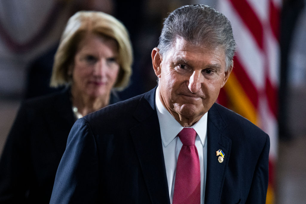 WASHINGTON, DC - JULY 14: Sen. Joe Manchin, D-W.Va., and Sen. Shelley Moore Capito, R-W.Va., pay respects to Hershel Woodrow Woody Williams in the United States Capitol Rotunda during a Congressional tribute ceremony on July 14, 2022 in Washington, DC. The last living WWII combat veteran to have received the Medal of Honor, Williams was a Marine corporal during the Battle of Iwo Jima in 1945 when he used his flamethrower to destroy numerous enemy pillboxes while under intense incoming fire for more than four hours. (Photo by Tom Williams-Pool/Getty Images)