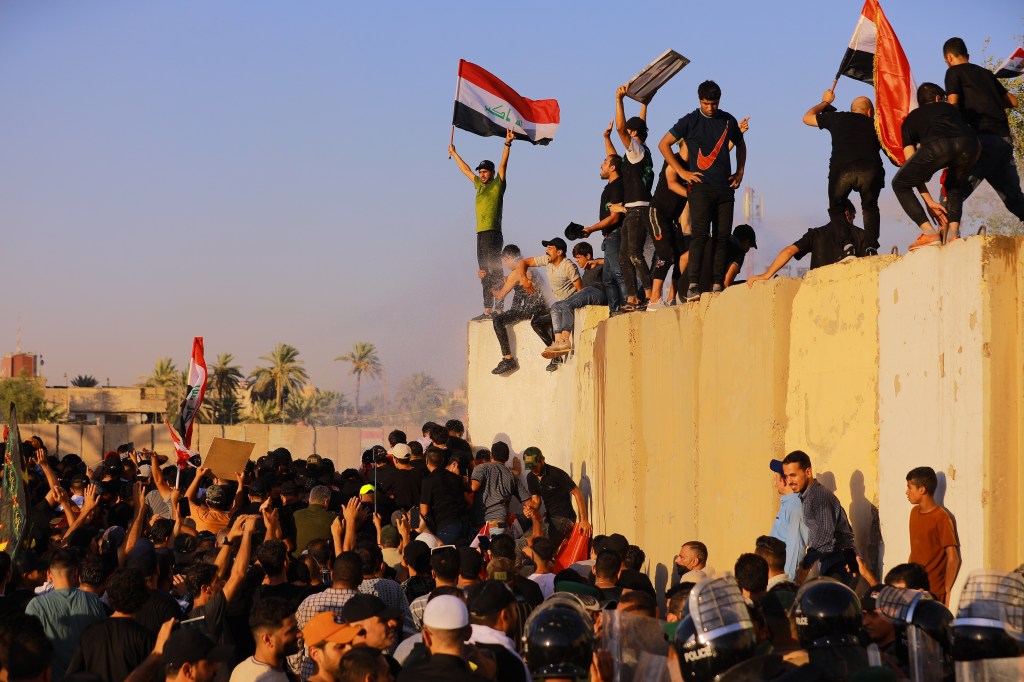 27 July 2022, Iraq, Baghdad: Supporters of Iraq's influential Shiite cleric Moqtada al-Sadr try to breach the Baghdad's fortified Green Zone, which houses parliament and many embassies, during a demonstration to demand political reforms amid a months-long deadlock in the country. Photo: Ameer Al-Mohammedawi/dpa (Photo by Ameer Al-Mohammedawi/picture alliance via Getty Images)