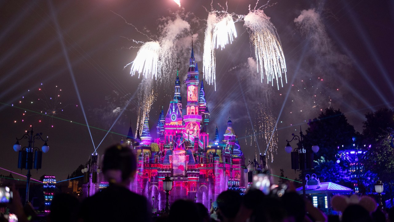 SHANGHAI, CHINA - JUNE 30: People attend the night show of the Enchanted Storybook Castle at Shanghai Disneyland on June 30, 2022 in Shanghai, China. (Photo by Hu Chengwei/Getty Images)