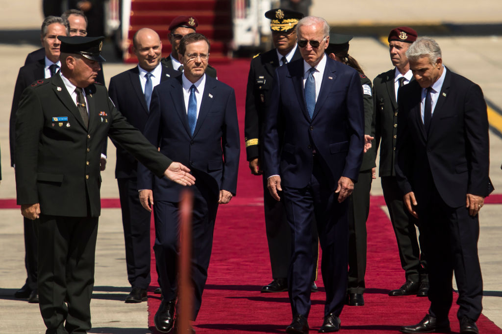 LOD, ISRAEL - JULY 13: U.S. President Joe Biden is welcomed by Israeli Prime Minister Yair Lapid and Israeli President Isaac Herzog during an arrival ceremony at Ben Gurion Airport on July 13, 2022 in Lod, Israel. Biden will spend two days in Israel, his first visit here as president, before traveling to Saudi Arabia. (Photo by Amir Levy/Getty Images)