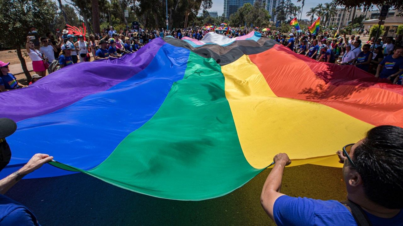 SAN DIEGO, CALIFORNIA - JULY 16: Participants carry a large Pride flag in the 2022 San Diego Pride Parade on July 16, 2022 in San Diego, California. (Photo by Daniel Knighton/Getty Images)