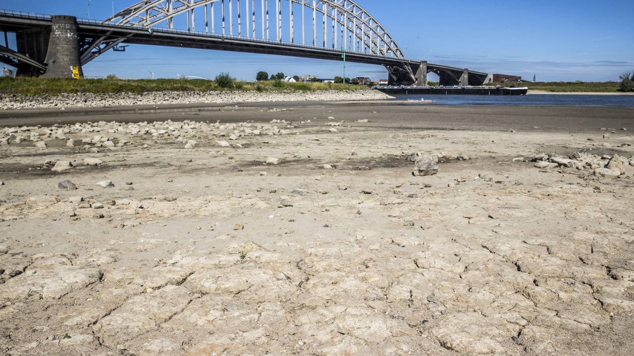 This illustration picture taken on July 24, 2022 shows low water level due to the ongoing drought, affecting shippings and houses in the Waal, near Nijmegen. Earlier this week, Rijkswaterstaat was forced to close the lock in the Maas-Waal Canal due to the very low water level in the Waal.Vincent Jannink / ANP / AFP