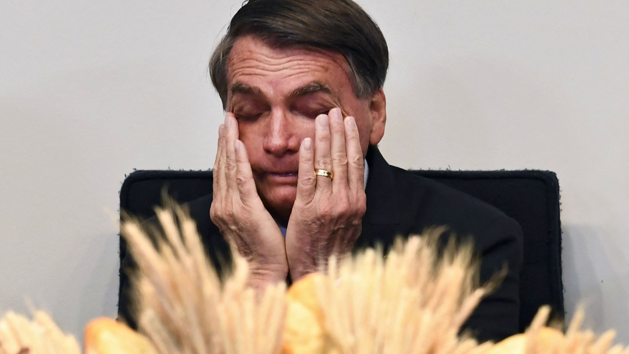 Brazilian President and candidate for reelection for the Liberal Party, Jair Bolsonaro, gestures during an evangelical service at the National Congress' Lower House in Brasilia, on August 3, 2022. - Bolsonaro trails former president Luiz Inacio Lula da Silva with the presidential election just two months away. (Photo by EVARISTO SA / AFP)