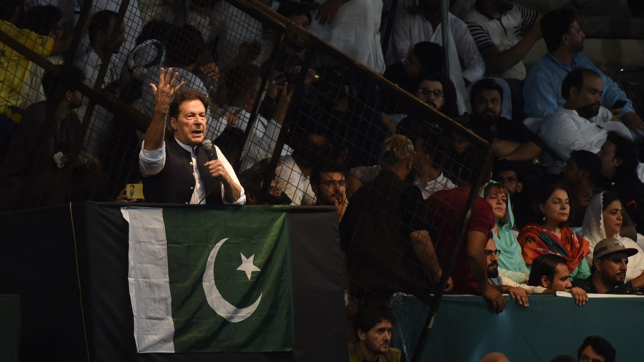 Pakistan's former Prime Minister and Pakistan Tehreek-e-Insaf party (PTI) chief Imran Khan, delivers a speech to his supporters during a rally to celebrate the 75th anniversary of Pakistan's independence day in Lahore on August 13, 2022. (Photo by Arif ALI / AFP)