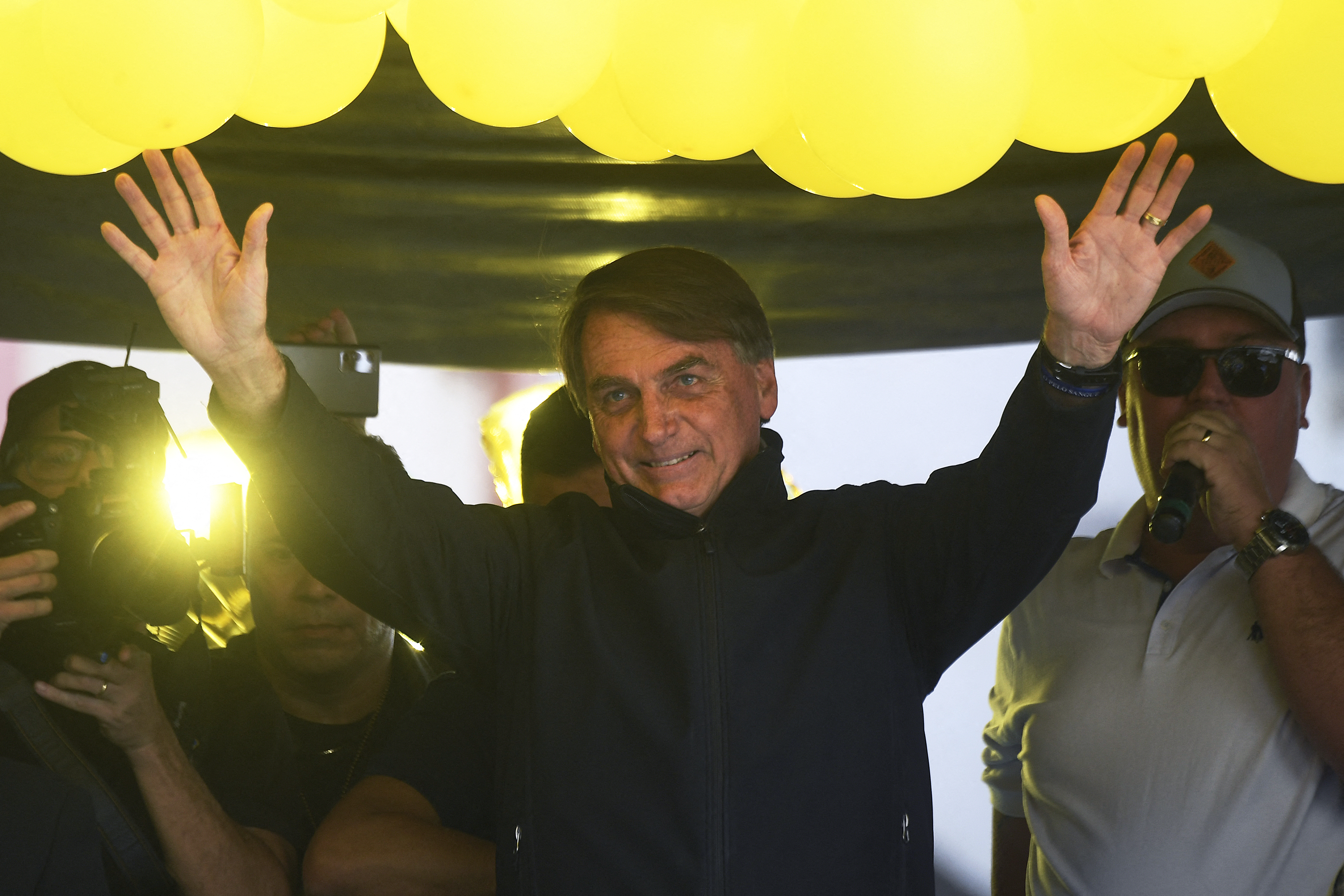 Brazil's President Jair Bolsonaro gestures during the launching of his re-election campaign for the upcoming national elections in October, in Juiz de Fora, Minas Gerais state, Brazil, on August 16, 2022. - Bolsonaro, 67, launched his campaign with a rally in Juiz de Fora, the small southeastern city where an attacker stabbed and nearly killed him during his 2018 campaign. The attack cemented Bolsonaro in the minds of die-hard supporters as "The Myth" -- a hero swooping in to rough up the political establishment and speak his mind with tough-talking clarity. (Photo by MAURO PIMENTEL / AFP)