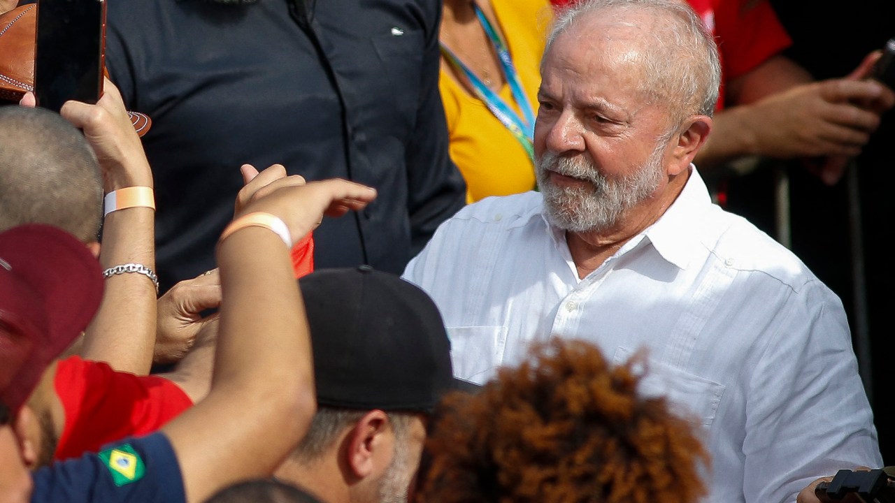 Brazilian presidential candidate for the leftist Workers Party (PT) and former President (2003-2010), Luiz Inacio Lula da Silva, greets his supporters during the launching of his campaign for the upcoming national elections in October on a rally at a Volkswagem car factory in Sao Bernardo do Campo, Sao Paulo, Brazil, on August 16, 2022. - Lula, 76, started his campaign with a visit to a Volkswagen plant in Sao Bernardo do Campo, in the industrial heartland of Sao Paulo state, where he launched his political career as a union leader. Lula currently leads with 44 percent of the vote to 32 percent for Bolsonaro, according to the latest poll from the Ipec institute, published Monday. (Photo by Miguel SCHINCARIOL / AFP)