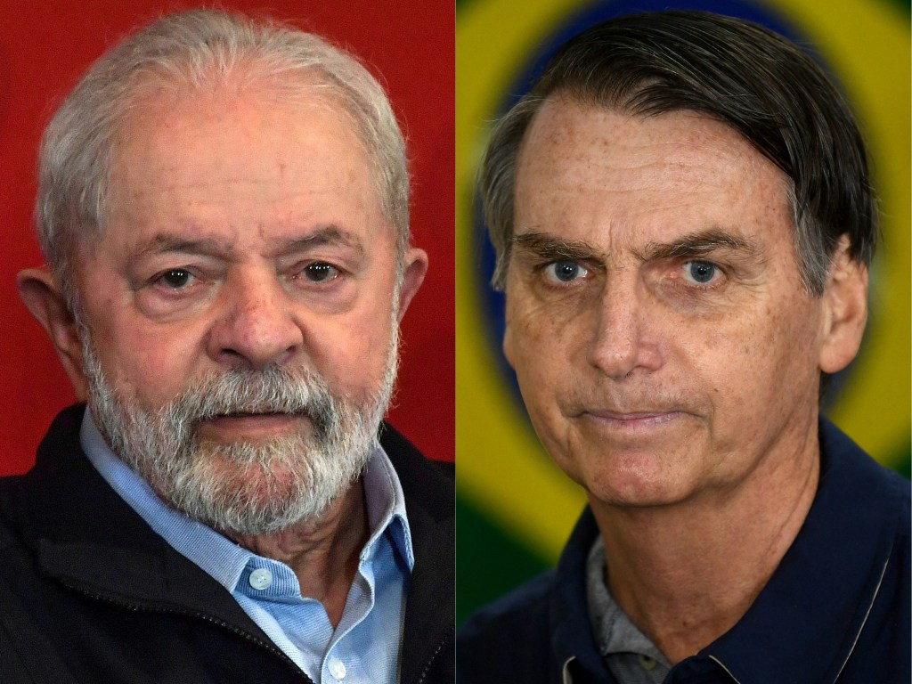 (COMBO) This combination of pictures created on August 16, 2022 shows a file photo taken on June 21, 2022, of former President (2003-2010) Luiz Inacio Lula da Silva (L) attending the launch of his government program guidelines in Sao Paulo, Brazil; and a file photo taken on October 7, 2018, of Brazil's right-wing then presidential candidate for the Social Liberal Party (PSL) Jair Bolsonaro (R) standing in front of the Brazilian flag as he prepares to cast his vote during the general elections in Rio de Janeiro, Brazil. - The race for Brazil's October elections formally opened on Tuesday August 16, 2022, with dueling campaign events by far-right incumbent Jair Bolsonaro and leftist ex-president Luiz Inacio Lula da Silva highlighting the South American giant's deep divides. Front-runners Bolsonaro and Lula, who have in reality been on the campaign trail for months, made it official on opening day with rival events showcasing their polar-opposite styles. (Photo by NELSON ALMEIDA and Mauro PIMENTEL / AFP)