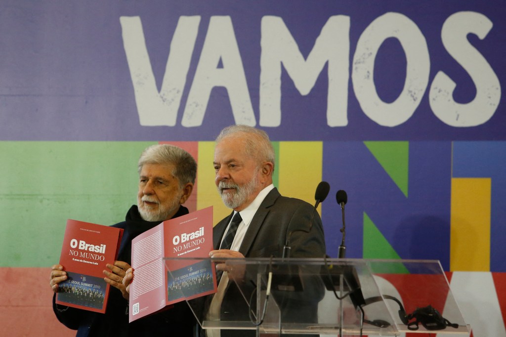 Brazilian President and presidential candidate Jair Bolsonaro (R) speaks next to Brazilian former president (2003-2010) and presidential candidate for the leftist Workers Party (PT), Luiz Inacio Lula da Silva (L), during a televised presidential debate in Sao Paulo, Brazil, on October 16, 2022. - President Jair Bolsonaro and former President Luiz Inácio Lula da Silva face each other this Sunday night in the first face-to-face debate, in which they will try to take advantage 14 days before the second round of the presidential elections in Brazil. (Photo by NELSON ALMEIDA / AFP)