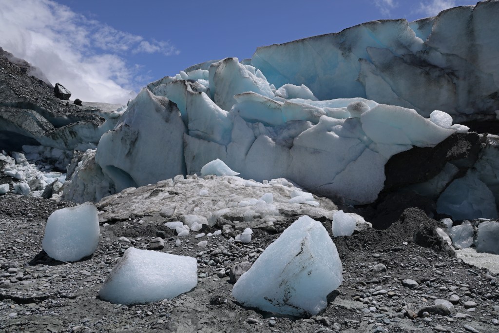 ZERMATT, SWITZERLAND - JUNE 22: Ice breaks off the receding Findel glacier on June 22, 2022 near Zermatt, Switzerland. The Findel glacier, which descends from the Monta Rosa massif, once filled a wide ravine running over two kilometers below its current terminus. Matthias Huss, a glaciologist with ETH Zurich university and head of the Swiss glacier monitoring network, has been studying the Findel and reports that the glacier is losing mass at a rate significantly faster than average since 2011. This summer is likely to be especially brutal for Switzerland’s glaciers. Normally in mid-June glaciers, including the Findel, would still be covered in snow that protects them from the sun, though because very little snow fell this year, the glaciers are already exposed and melting rapidly under conditions that are more typical for late July or August. Huss and his colleagues are studying approximately 20 glaciers across Switzerland to observe the effects of global warming. All of the glaciers are melting, and he predicts that if we do not meet global climate goals Switzerland’s glaciers will be mostly gone by 2100. (Photo by Sean Gallup/Getty Images)