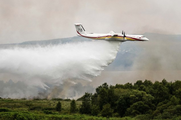 Uma aeronave De Havilland Canada Dash 8-400 MR lança água sobre um incêndio florestal em Monts d'Arree, região de Brennilis, na Bretanha, em 20/07/2022.