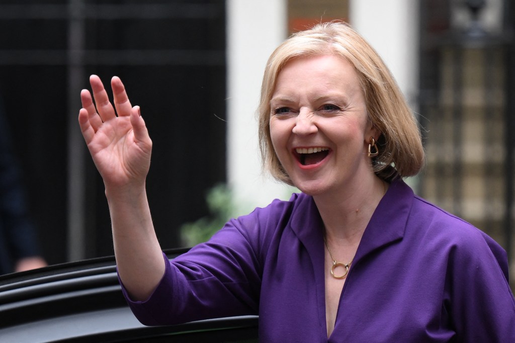 New Conservative Party leader and incoming prime minister Liz Truss smiles and waves as she arrives at Conservative Party Headquarters in central London having been announced the winner of the Conservative Party leadership contest at an event in central London on September 5, 2022. - Truss is the UK's third female prime minister following Theresa May and Margaret Thatcher. The 47-year-old has consistently enjoyed overwhelming support over 42-year-old Sunak in polling of the estimated 200,000 Tory members who were eligible to vote. (Photo by Daniel LEAL / AFP)
