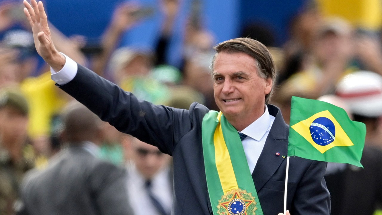 Brazilian President Jair Bolsonaro waves at the crowd during a military parade to mark Brazil's 200th anniversary of independence in Brasilia, on September 7, 2022. (Photo by EVARISTO SA / AFP)