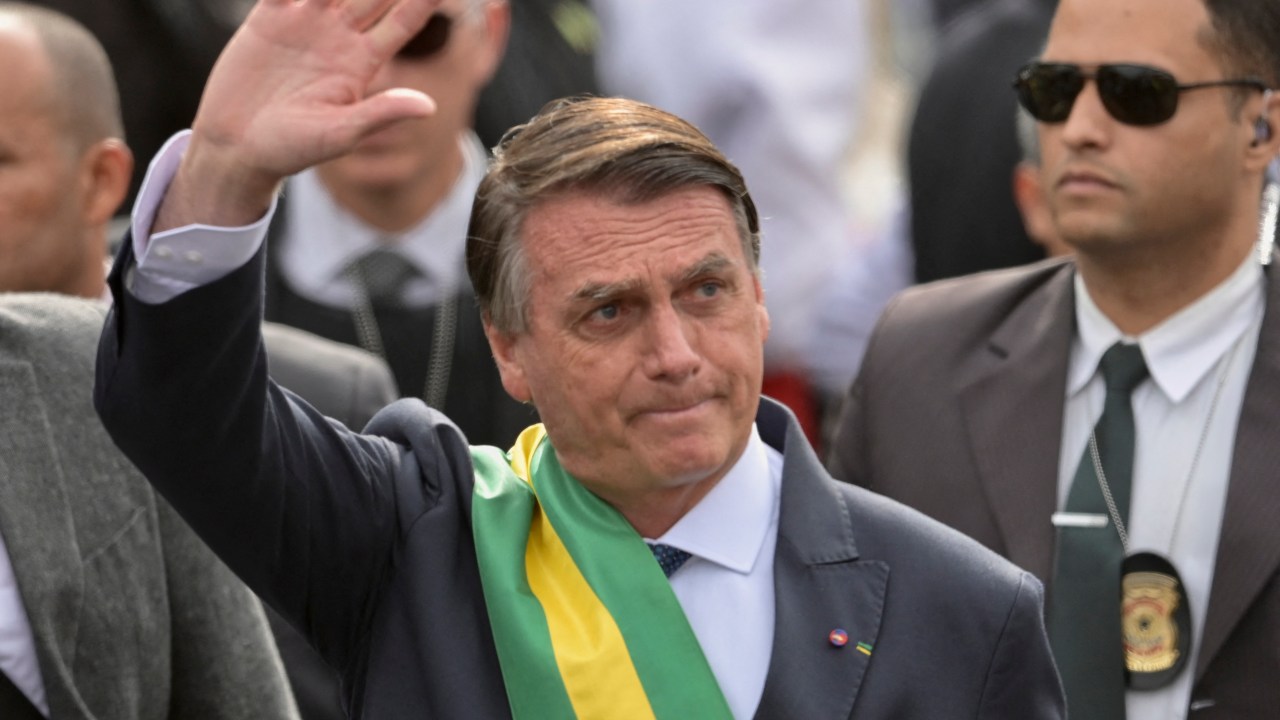 Brazilian President Jair Bolsonaro waves during a military parade to mark Brazil's 200th anniversary of independence in Brasilia, on September 7, 2022. (Photo by EVARISTO SA / AFP)