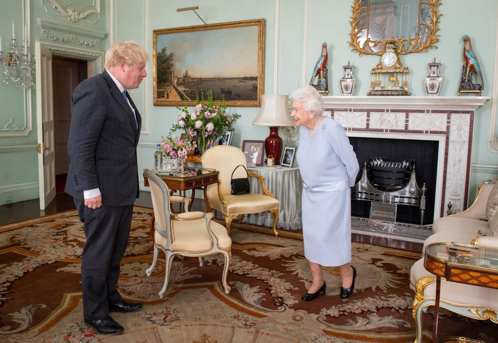 (FILES) In this file photo taken on June 23, 2021 Britain's Queen Elizabeth II greets Britain's Prime Minister Boris Johnson during an audience at Buckingham Palace in central London, the Queen's first in-person weekly audience with the Prime Minister since the start of the coronavirus pandemic. - Queen Elizabeth II, the longest-serving monarch in British history and an icon instantly recognisable to billions of people around the world, has died aged 96, Buckingham Palace said on September 8, 2022. Her eldest son, Charles, 73, succeeds as king immediately, according to centuries of protocol, beginning a new, less certain chapter for the royal family after the queen's record-breaking 70-year reign. (Photo by Dominic Lipinski / POOL / AFP)