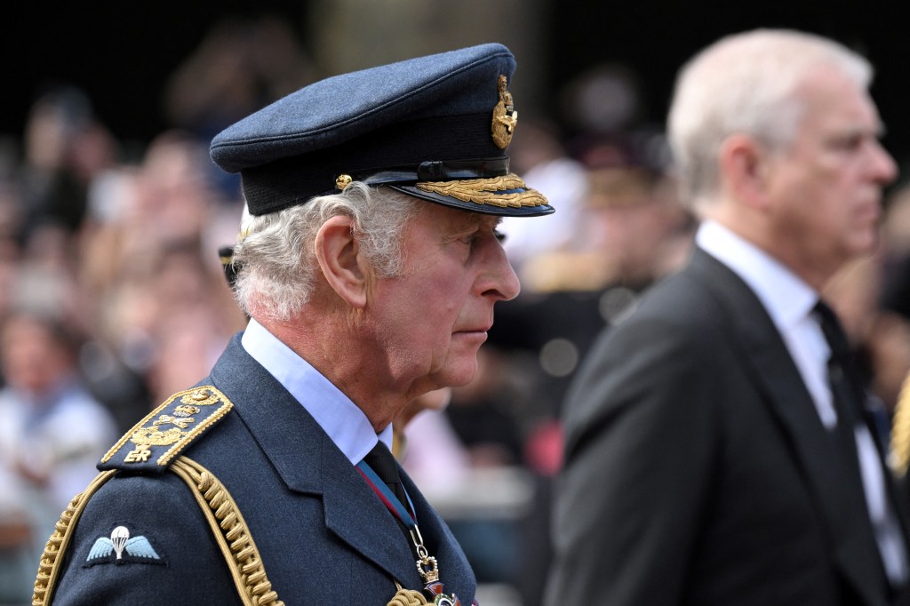 Britain's King Charles III (L) and Britain's Prince Andrew, Duke of York walk behind the coffin of Queen Elizabeth II, adorned with a Royal Standard and the Imperial State Crown and pulled by a Gun Carriage of The King's Troop Royal Horse Artillery, during a procession from Buckingham Palace to the Palace of Westminster, in London on September 14, 2022. - Queen Elizabeth II will lie in state in Westminster Hall inside the Palace of Westminster, from Wednesday until a few hours before her funeral on Monday, with huge queues expected to file past her coffin to pay their respects. (Photo by LOIC VENANCE / AFP)