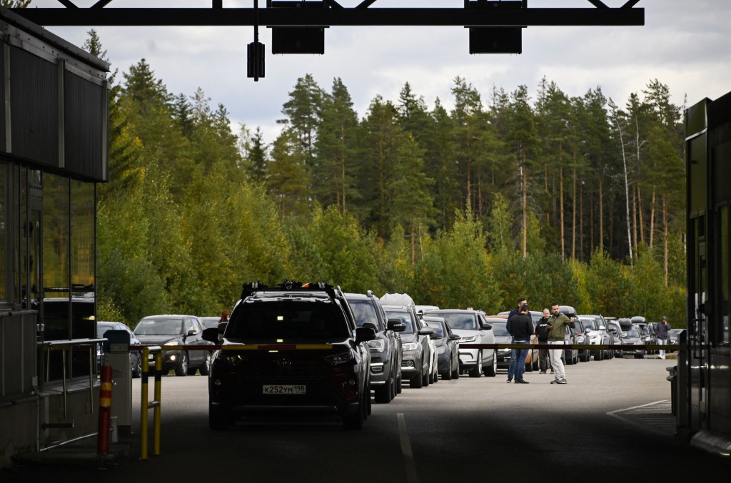 Cars coming from Russia wait in long lines at the border checkpoint between Russia and Finland near Vaalimaa, on September 22, 2022. - Finland said on September 21, 2022 it was is preparing a national solution to "limit or completely prevent" tourism from Russia following the invasion of Ukraine. Since Russia's Covid-19 restrictions expired in July, there has been a boom in Russian travellers and a rising backlash in Europe against allowing in Russian tourists while the war continues. (Photo by Olivier MORIN / AFP)