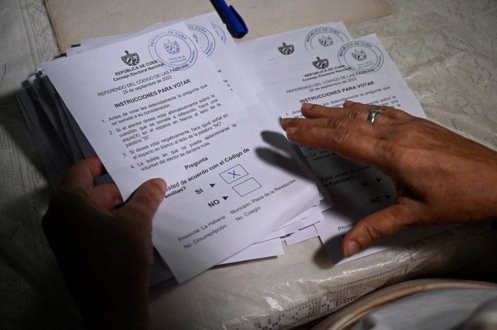 A member of the electoral authorities counts ballots at a polling station in Havana, on September 25, 2022. - Cubans went to the polls Sunday to vote in a landmark referendum on whether to legalize same-sex marriage and adoption, allow surrogate pregnancies and give greater rights to non-biological parents. (Photo by YAMIL LAGE / AFP)