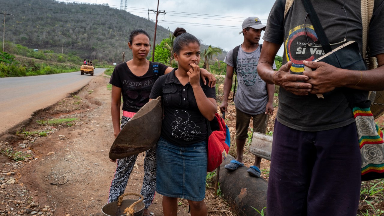 EL CALLAO VENEZUELA - MAY 13 Miners prepare to walk to a gold mine after disembarking a bus in El Callao , Venezuela on May 13, 2019. The group is from northern Venezuela but like many have come to try and make some money in the dangerous and crime infested gold mining towns in Bolivar state in the southeast of the country. (Photo by Michael Robinson Chavez/The Washington Post via Getty Images)