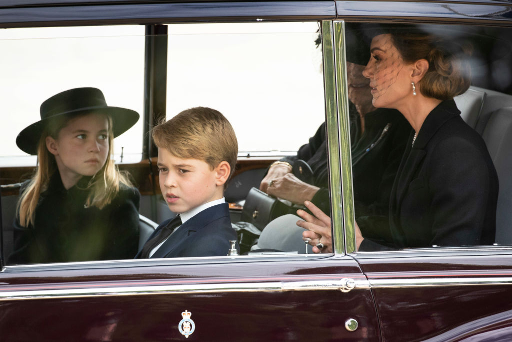LONDON, ENGLAND - SEPTEMBER 19: Camilla, Queen Consort, Catherine, Princess of Wales, Prince George of Wales, Princess Charlotte of Wales follow the cortège of the late Queen Elizabeth II as it is pulled past the Houses of Parliament after her funeral at Westminster Abbey on September 19, 2022 in London, England. Elizabeth Alexandra Mary Windsor was born in Bruton Street, Mayfair, London on 21 April 1926. She married Prince Philip in 1947 and ascended the throne of the United Kingdom and Commonwealth on 6 February 1952 after the death of her Father, King George VI. Queen Elizabeth II died at Balmoral Castle in Scotland on September 8, 2022, and is succeeded by her eldest son, King Charles III. (Photo by Joshua Bratt- WPA Pool/Getty Images)