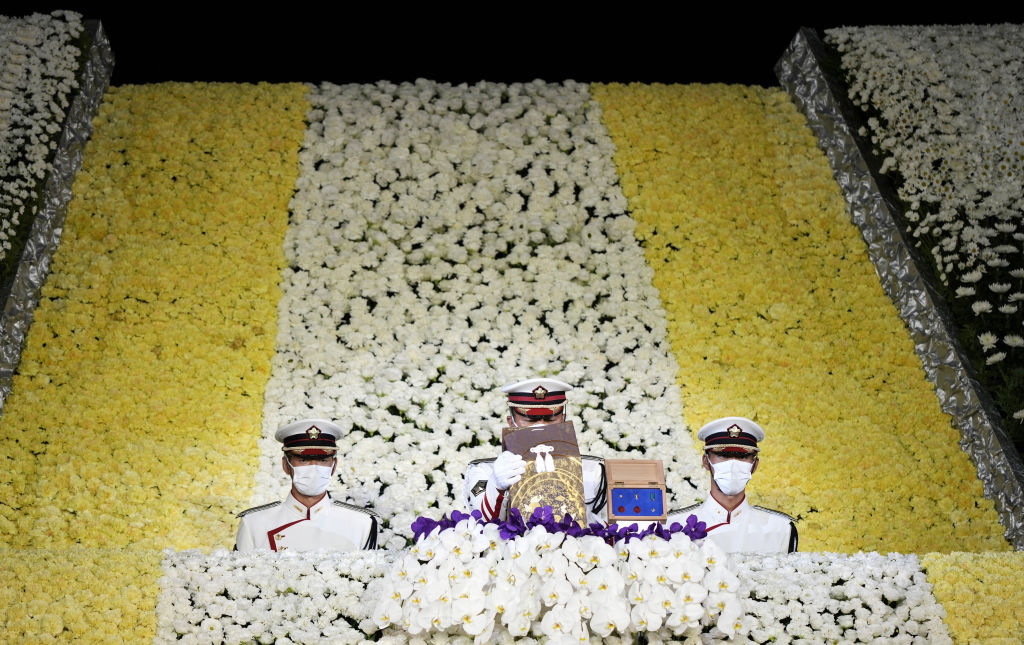 TOKYO, JAPAN - SEPTEMBER 27: Members of an honour guard carry the ashes of Japan's former prime minister Shinzo Abe from the altar after the state funeral for Abe on September 27, 2022 at the Budokan in Tokyo, Japan. Several current and former heads of state visited Japan for the state funeral of Abe, who was assassinated in July while campaigning on a street. (Photo by Franck Robichon/Pool/Getty Images)
