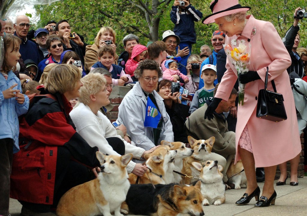Britain's Queen Elizabeth II is greeted by local corgi enthusiasts as she departs the Legislature Building. (Photo by Fiona Hanson - PA Images/PA Images via Getty Images)