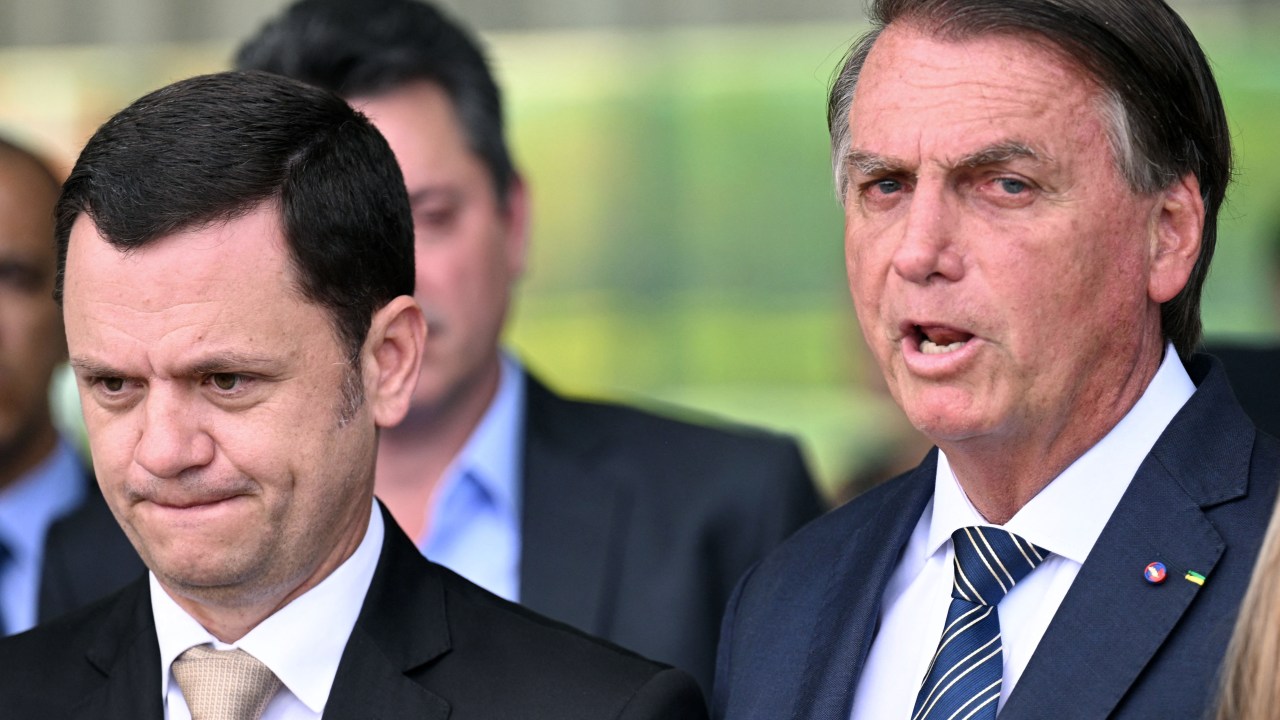 Brazilian President and re-election candidate Jair Bolsonaro (R) speaks to the press next to Justice Minister Anderson Torres, at Alvorada Palace in Brasilia, on October 5, 2022. - Brazil's bitterly divisive presidential election will be decided in a runoff on October 30 as incumbent Jair Bolsonaro beat first-round expectations to finish a closer-than-expected second to front-runner Luiz Inacio Lula da Silva in the October 2 first round. (Photo by EVARISTO SA / AFP)