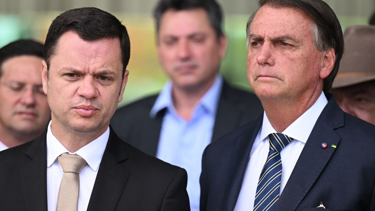 Brazilian President and re-election candidate Jair Bolsonaro (R) and Justice Minister Anderson Torres listen to the press, at Alvorada Palace in Brasilia, on October 5, 2022. - Brazil's bitterly divisive presidential election will be decided in a runoff on October 30 as incumbent Jair Bolsonaro beat first-round expectations to finish a closer-than-expected second to front-runner Luiz Inacio Lula da Silva in the October 2 first round. (Photo by EVARISTO SA / AFP)