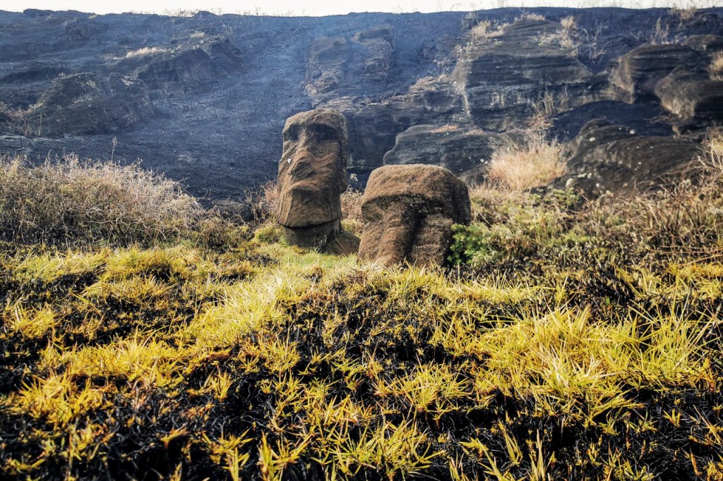This handout picture released by the Rapanui Municipality shows Moais -- stone statues of the Rapa Nui culture -- affected by a fire at the Rapa Nui National Park in Easter Island, Chile, on October 6, 2022. (Photo by Rapanui Municipality / AFP) / RESTRICTED TO EDITORIAL USE - MANDATORY CREDIT "AFP PHOTO / RAPANUI MUNICIPALITY" - NO MARKETING NO ADVERTISING CAMPAIGNS - DISTRIBUTED AS A SERVICE TO CLIENTS