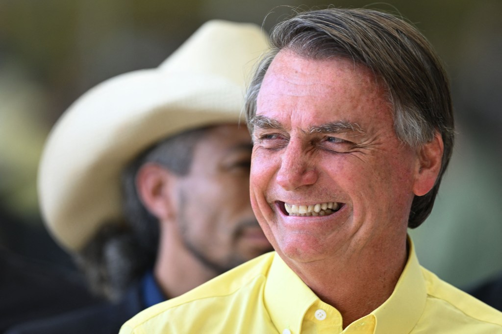 Brazilian President and presidential candidate Jair Bolsonaro gestures during a meeting with country singers at the Alvorada Palace in Brasilia, Brazil, on October 17, 2022. - Lula da Silva and president Jair Bolsonaro will face in the second round of a presidential election on October 30, with the expectation of a close contest pushing both sides to intensify their attacks in the run-up. (Photo by EVARISTO SA / AFP)