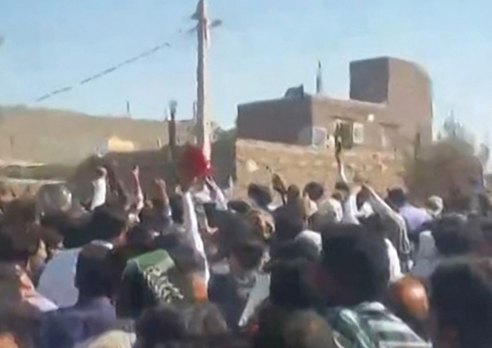 This grab from a UGC video posted on October 21, 2022, shows demonstrators gesturing as they march on a street in the southeastern Iranian city of Zahedan. - Cities across Iran have seen protests since 22-year-old Iranian woman Mahsa Amini died on September 16, after her arrest by the morality police in Tehran for allegedly failing to observe the Islamic republic's strict dress code for women. (Photo by UGC / AFP) / Israel OUT / XGTY/RESTRICTED TO EDITORIAL USE - MANDATORY CREDIT AFP - SOURCE: ANONYMOUS - NO MARKETING - NO ADVERTISING CAMPAIGNS - NO INTERNET - DISTRIBUTED AS A SERVICE TO CLIENTS - NO RESALE - NO ARCHIVE -NO ACCESS ISRAEL MEDIA/PERSIAN LANGUAGE TV STATIONS OUTSIDE IRAN/ STRICTLY NO ACCESS BBC PERSIAN/ VOA PERSIAN/ MANOTO-1 TV/ IRAN INTERNATIONAL/RADIO FARDA - AFP IS NOT RESPONSIBLE FOR ANY DIGITAL ALTERATIONS TO THE PICTURE'S EDITORIAL CONTENT /