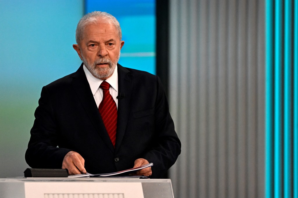 Brazilian former president (2003-2010) and presidential candidate for the Workers' Party (PT) Luiz Inacio Lula da Silva (PT) arranges his papers before the start of the television debate at the Globo TV studio in Rio de Janeiro, Brazil, on October 28, 2022. - After a bitterly divisive campaign and inconclusive first-round vote, Brazil will elect its next president on October 30, in a cliffhanger runoff between far-right incumbent Jair Bolsonaro and veteran leftist Luiz Inacio Lula da Silva. (Photo by MAURO PIMENTEL / AFP)