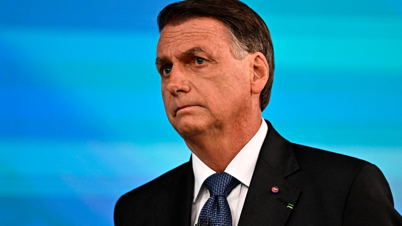 Brazilian President and reelection candidate for the Liberal Party (PL) Jair Bolsonaro gestures before the start of the television debate at the Globo TV studio in Rio de Janeiro, Brazil, on October 28, 2022. - After a bitterly divisive campaign and inconclusive first-round vote, Brazil will elect its next president on October 30, in a cliffhanger runoff between far-right incumbent Jair Bolsonaro and veteran leftist Luiz Inacio Lula da Silva. (Photo by MAURO PIMENTEL / AFP)