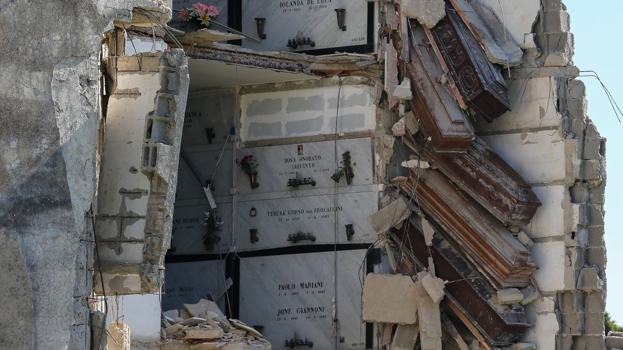 NAPLES, ITALY - 2022/10/18: A view of the partially collapsed building inside the Poggioreale cemetery in Naples, with the coffins suspended in the void. The cemetery was closed due to the danger of a further collapse. (Photo by Marco Cantile/LightRocket via Getty Images)