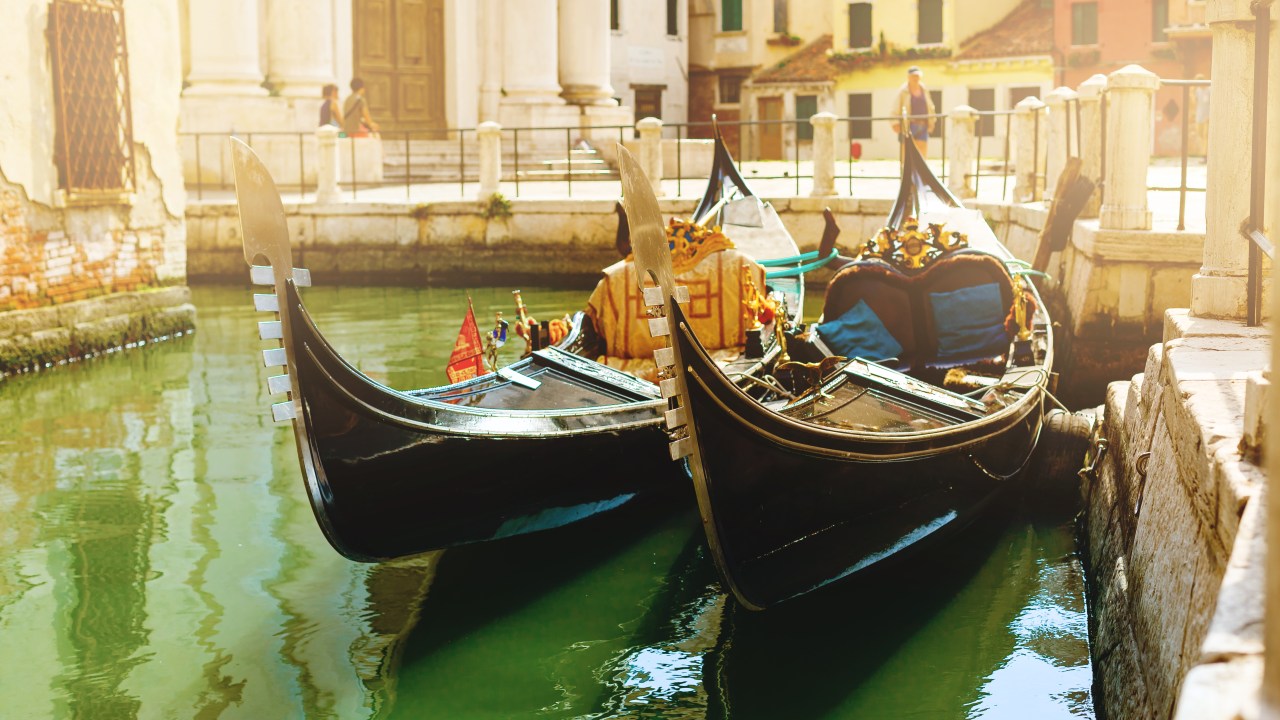 Canal with two gondolas in Venice, Italy. Architecture and landmarks of Venice. Venice postcard with Venice gondolas.