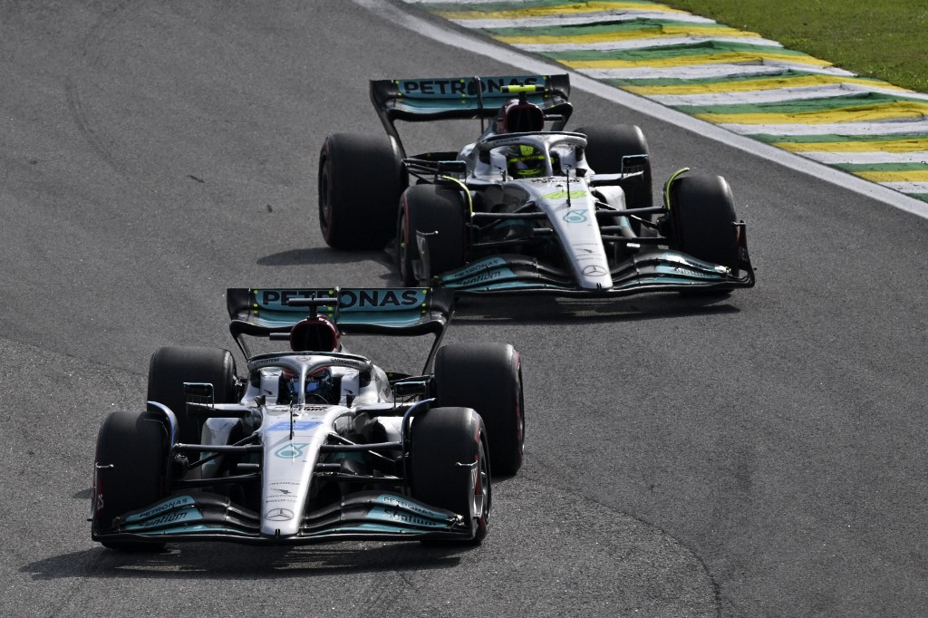 Mercedes' British driver George Russell is chased by his teammate British driver Lewis Hamilton during the start of the Formula One Brazil Grand Prix at the Autodromo Jose Carlos Pace racetrack, also known as Interlagos, in Sao Paulo, Brazil, on November 13, 2022. (Photo by NELSON ALMEIDA / AFP)