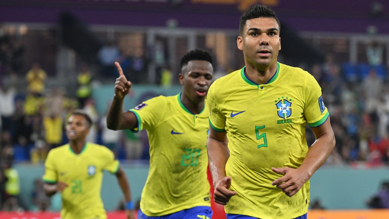 Brazil's midfielder #05 Casemiro (R) celebrates with Brazil's forward #20 Vinicius Junior after he scored his team's first goal during the Qatar 2022 World Cup Group G football match between Brazil and Switzerland at Stadium 974 in Doha on November 28, 2022. (Photo by NELSON ALMEIDA / AFP)
