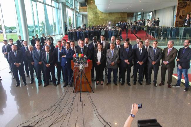 O presidente Jair Bolsonaro, acompanhado de vários ministros e aliados, faz pronunciamento no Palácio da Alvorada nesta terça