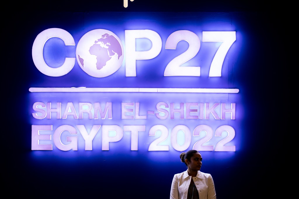 08 November 2022, Egypt, Sharm El-Sheikh: A girl stands in front of the logo of the 2022 United Nations Climate Change Conference COP27, at the International Convention Center. Photo: Gehad Hamdy/dpa (Photo by Gehad Hamdy/picture alliance via Getty Images)