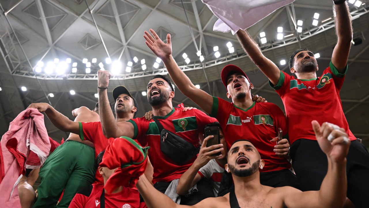 Morocco supporters celebrate after their team won the Qatar 2022 World Cup quarter-final football match between Morocco and Portugal at the Al-Thumama Stadium in Doha on December 10, 2022. (Photo by Kirill KUDRYAVTSEV / AFP)