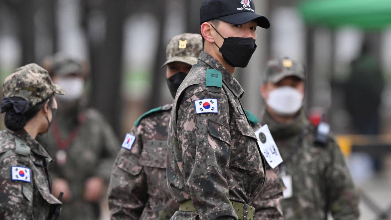 South Korean soldiers stand at the main gate of a military training unit in Yeoncheon on December 13, 2022, as the place where BTS singer Jin is scheduled to arrive to begin his military service. - BTS star Jin starts his mandatory South Korean military duty on December 13, 2022, the first band member to enlist since their hiatus announcement this year left fans heartbroken and wondering if this was the end for the K-pop juggernaut. (Photo by Jung Yeon-je / AFP)