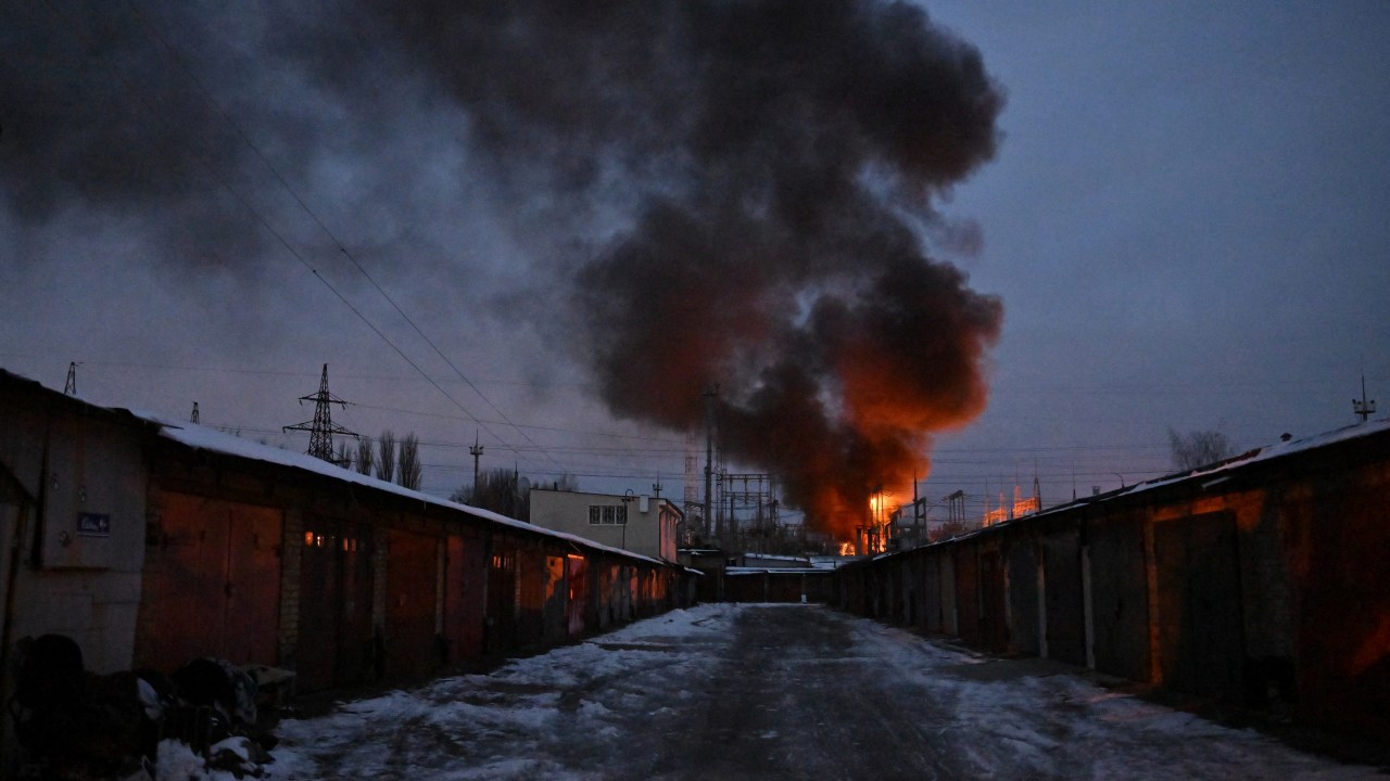 This photograph shows an object of a critical power infrastructure as it burns after a drone attack to Kyiv, amid the Russian invasion of Ukraine. - Drones attacked the Ukrainian capital early on December 19, 2022 morning, the Kyiv city military administration said, urging people to heed air alerts. (Photo by Sergei SUPINSKY / AFP)