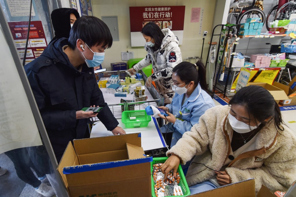 A man buys fever medicine at a pharmacy amid the Covid-19 pandemic in Nanjing, in China's eastern Jiangsu province, on December 19, 2022, as the pharmacy offers six capsules for each client. (Photo by AFP) / China OUT