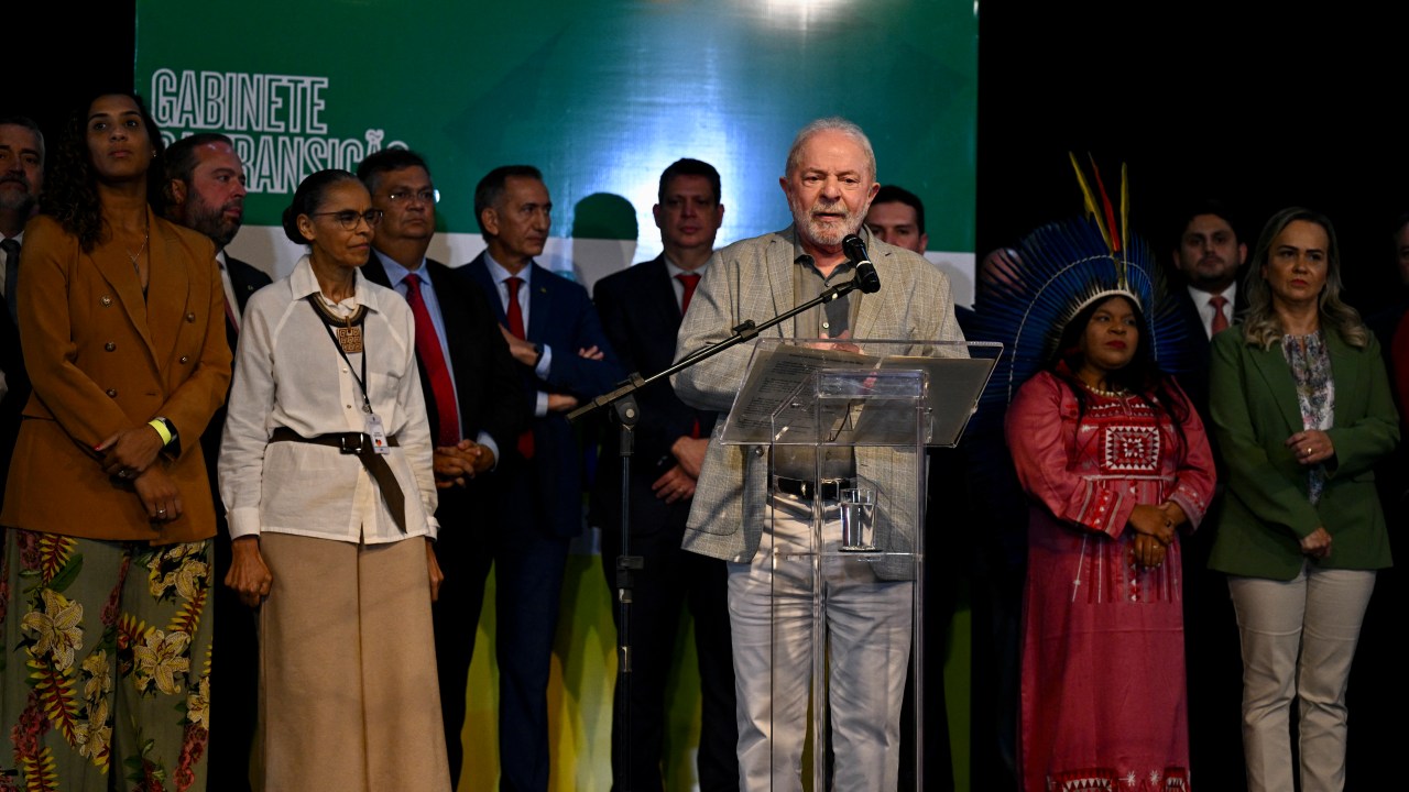 Brazil's President-elect Luiz Inacio Lula da Silva speaks during a press conference in which he announced the names of the ministers who will comprise his cabinet at the transitional government building in Brasilia on December 29, 2022. - Luiz Inacio Lula da Silva appointed this Thursday the environmentalist Marina Silva as Minister of Environment, and the indigenous leader Sonia Guajajara at the head of the unprecedented portfolio of Original Peoples, completing his cabinet three days before beginning his third presidential term in Brazil. (Photo by EVARISTO SA / AFP)