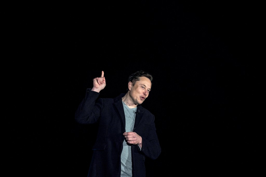 Elon Musk gestures as he speaks during a press conference at SpaceX's Starbase facility near Boca Chica Village in South Texas on February 10, 2022. - Billionaire entrepreneur Elon Musk delivered an eagerly-awaited update on SpaceX's Starship, a prototype rocket the company is developing for crewed interplanetary exploration. (Photo by JIM WATSON / AFP)
