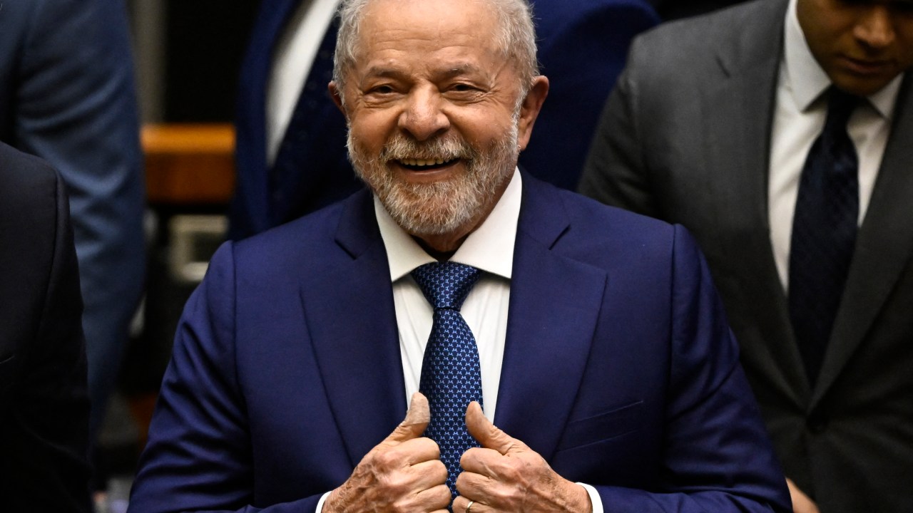 Brazil's new President Luiz Inacio Lula da Silva gives his thumbs up after swearing in during his inauguration ceremony at the National Congress, in Brasilia, on January 1, 2023. - Lula da Silva, a 77-year-old leftist who already served as president of Brazil from 2003 to 2010, takes office for the third time with a grand inauguration in Brasilia. (Photo by MAURO PIMENTEL / AFP)